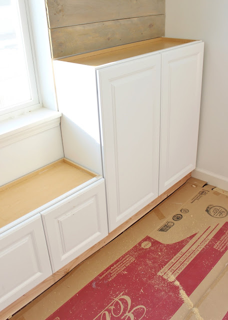 DIY built-in with decked out stock cabinets. What a terrific way to add stylish and functional storage to a room! Step-by-step tutorial included.